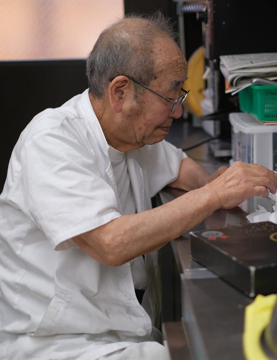 板場に座り、黙々と手を動かす初代